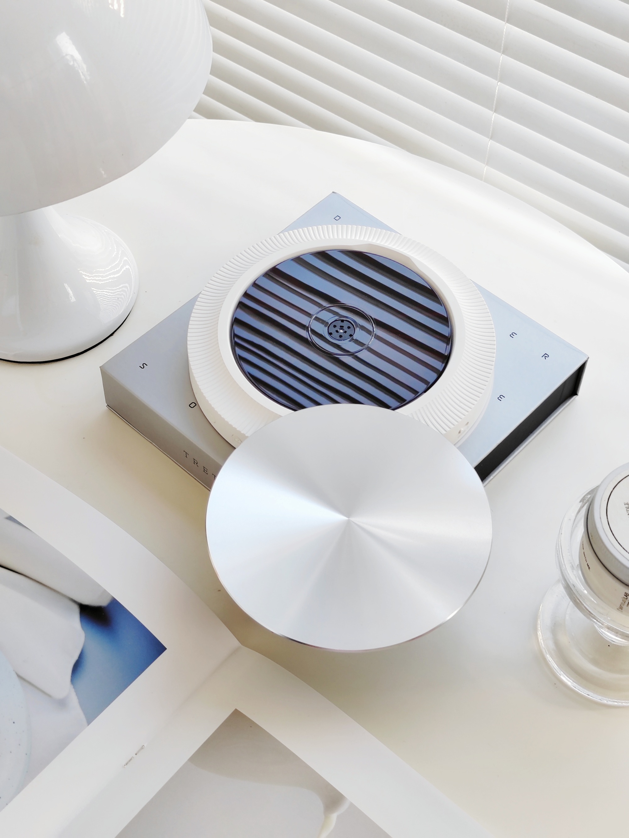 a modern cd player on a minimalist table