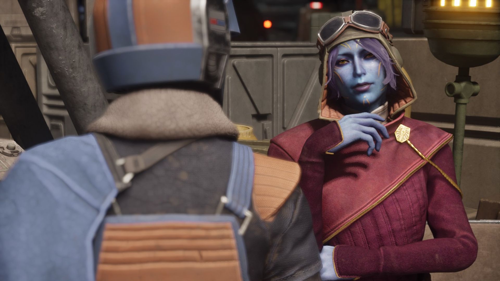 A blue alien with pilot's goggles on her head