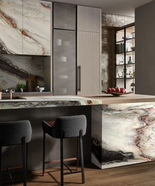 A moody kitchen with statement marble and fluted kitchen cabinets