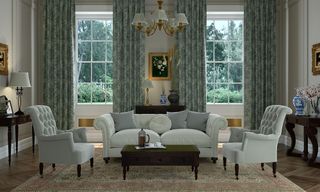 living room with white sofa white windows with curtains chandelier and designed matt