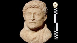 This statue also depicts one of the deceased, a man whose hairstyle is shown in detail.