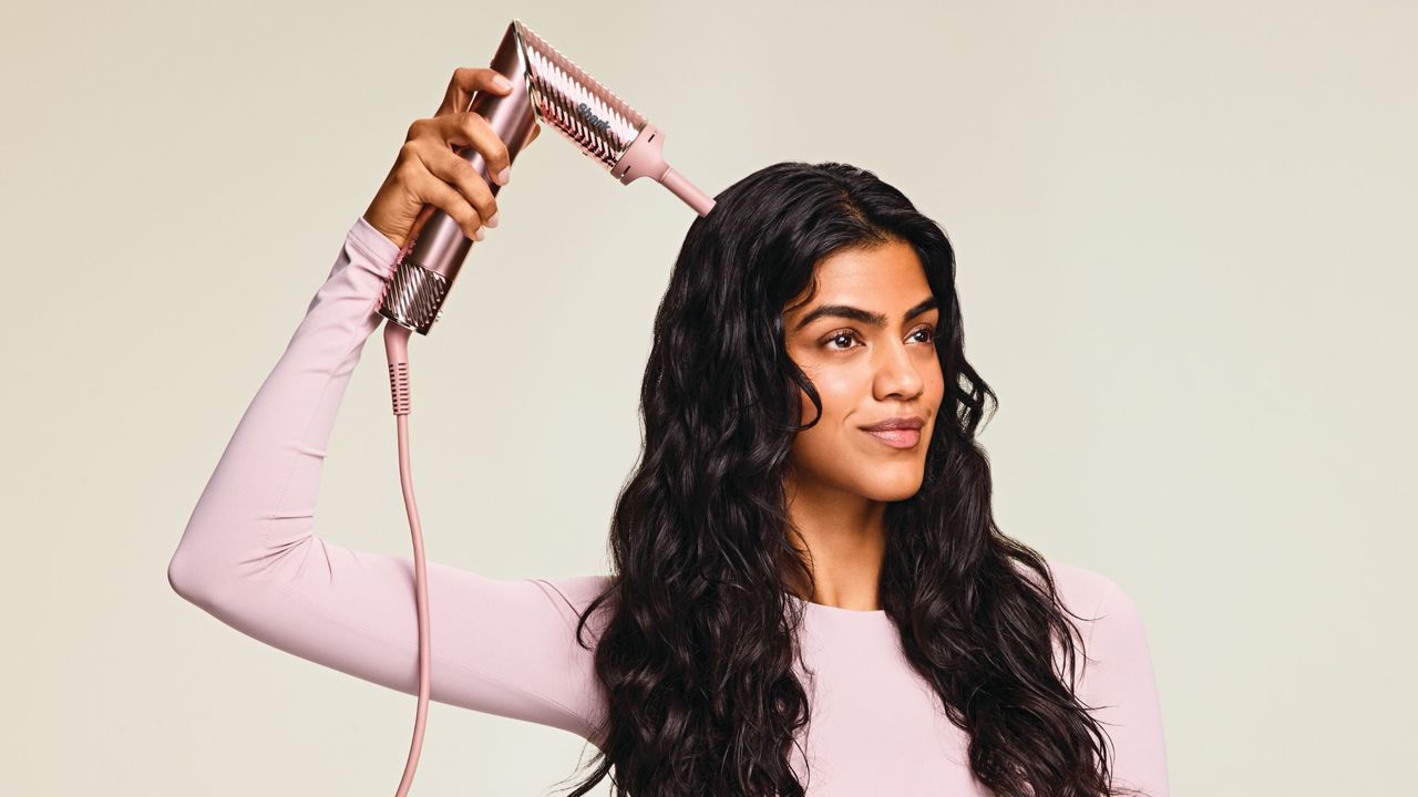 Woman styling hair using Shark FlexStyle IonCurl