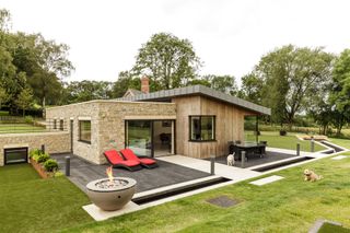 pond and paving beside decked patio area