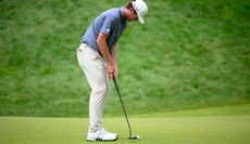 Nick Dunlap hits a putt