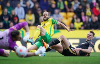 Norwich striker Teemu Pukki (left) shoots at goal,