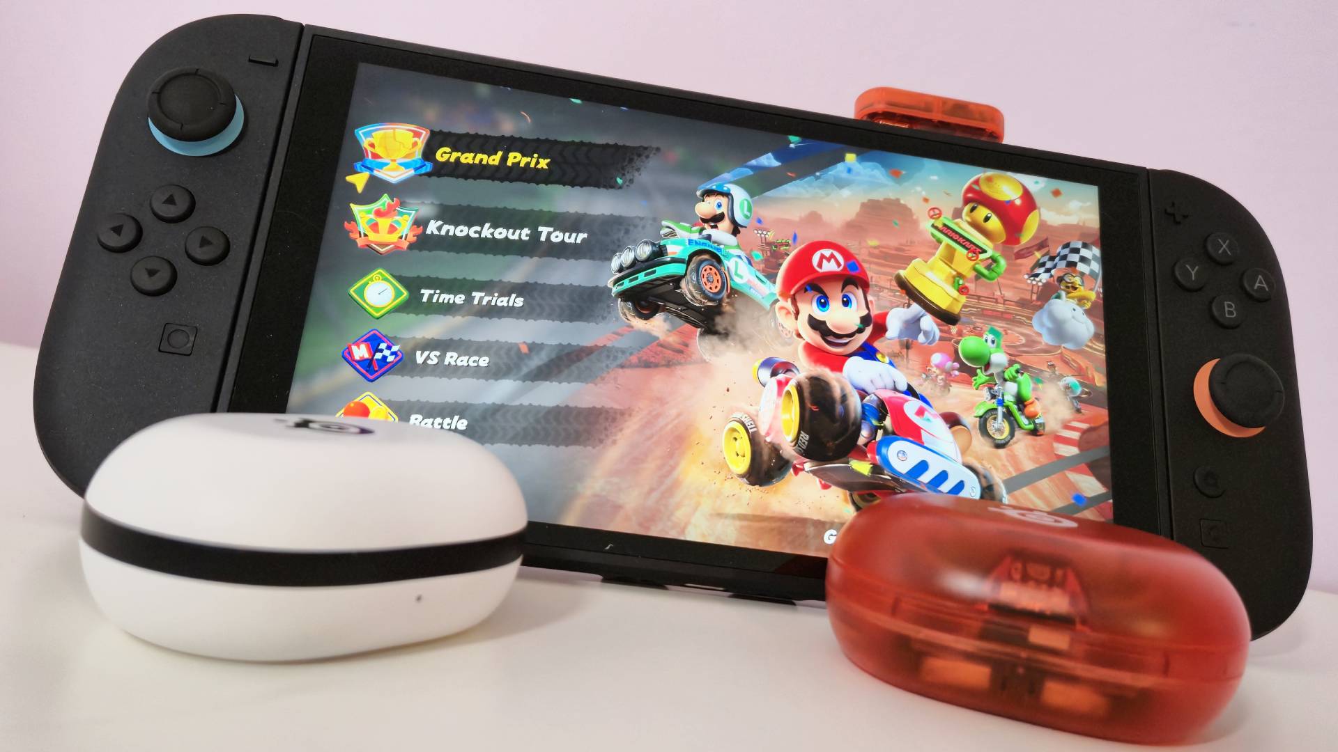 Photo by Rosalie Newcombe of the limited edition SteelSeries Game Buds attached to a Nintendo Switch 2.
