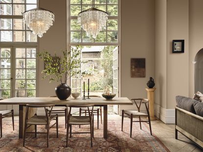 A dining room in a soft pink neutral color