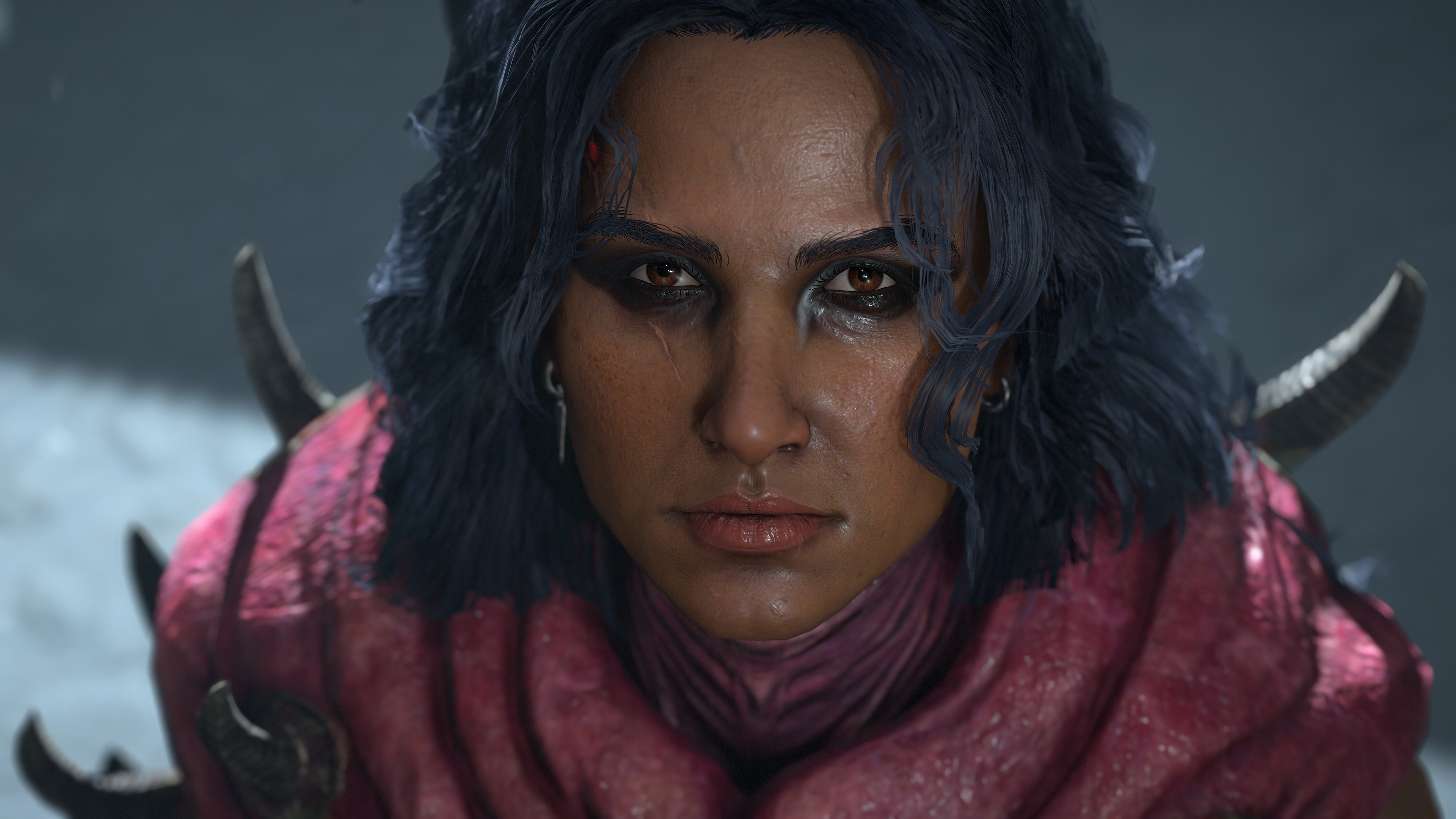 A close-up of a player character warlock in Diablo 4: Lord of Hatred. She looks toward the viewer while standing in glowing bright light.