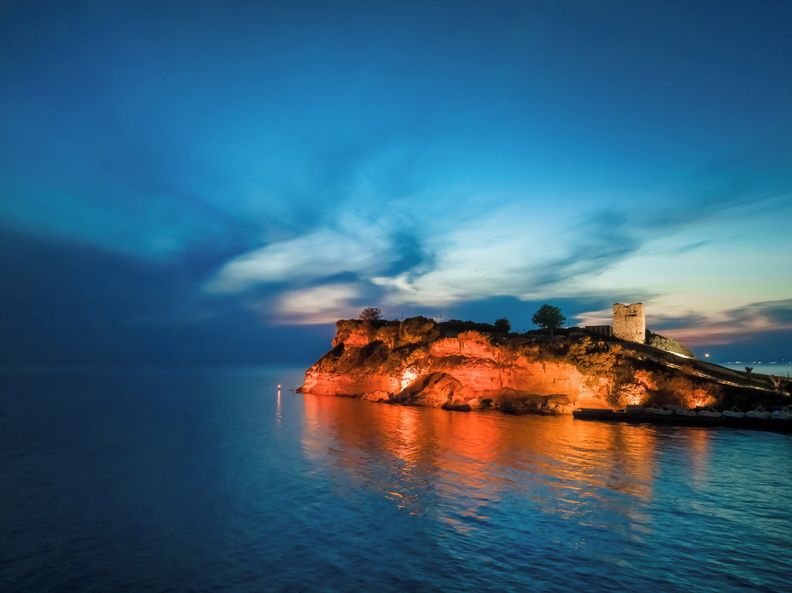 Sani Hill at night lit up to show the cliffs and Byzantine Tower that are part of the resort