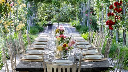 table setting beneath pergola for backyard wedding ideas