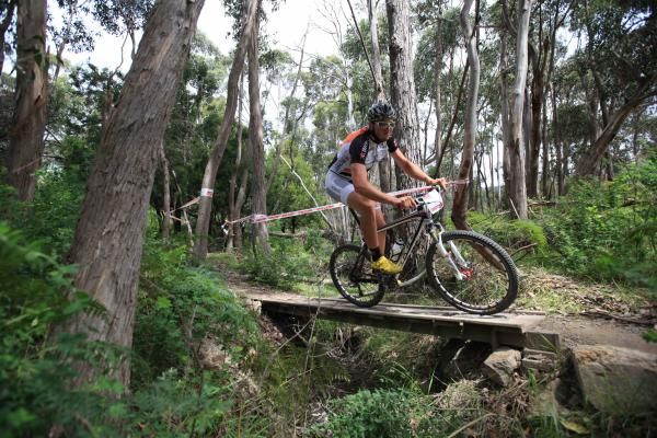 Paul van der Ploeg crosses a bridge on the cross country course.