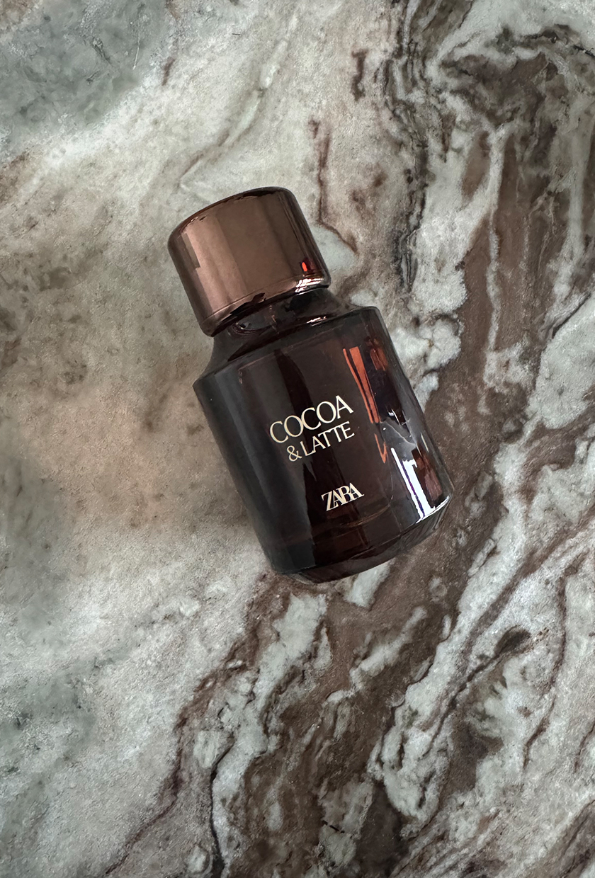 A picture of Zara cocoa latte perfume on a marble surface