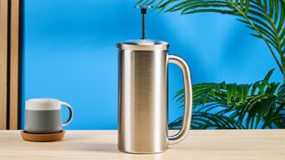 the espro p7 french press dual walled filter in silver photographed against a blue background