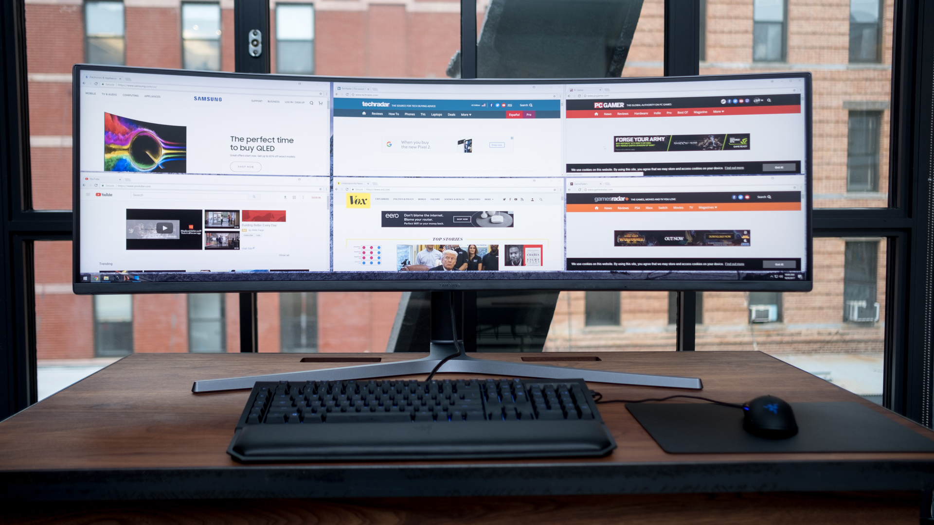 A curved monitor on a desk.