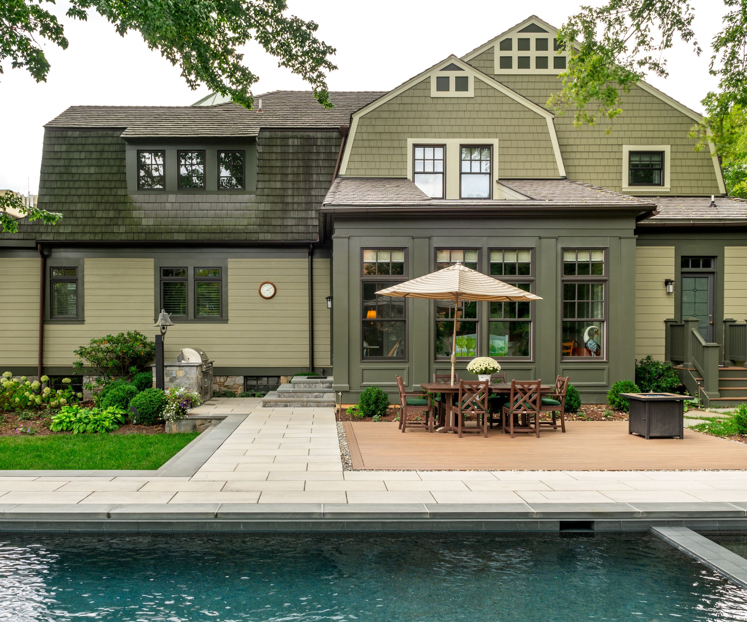 House exterior painted in a tonal nature-merged palette of greens