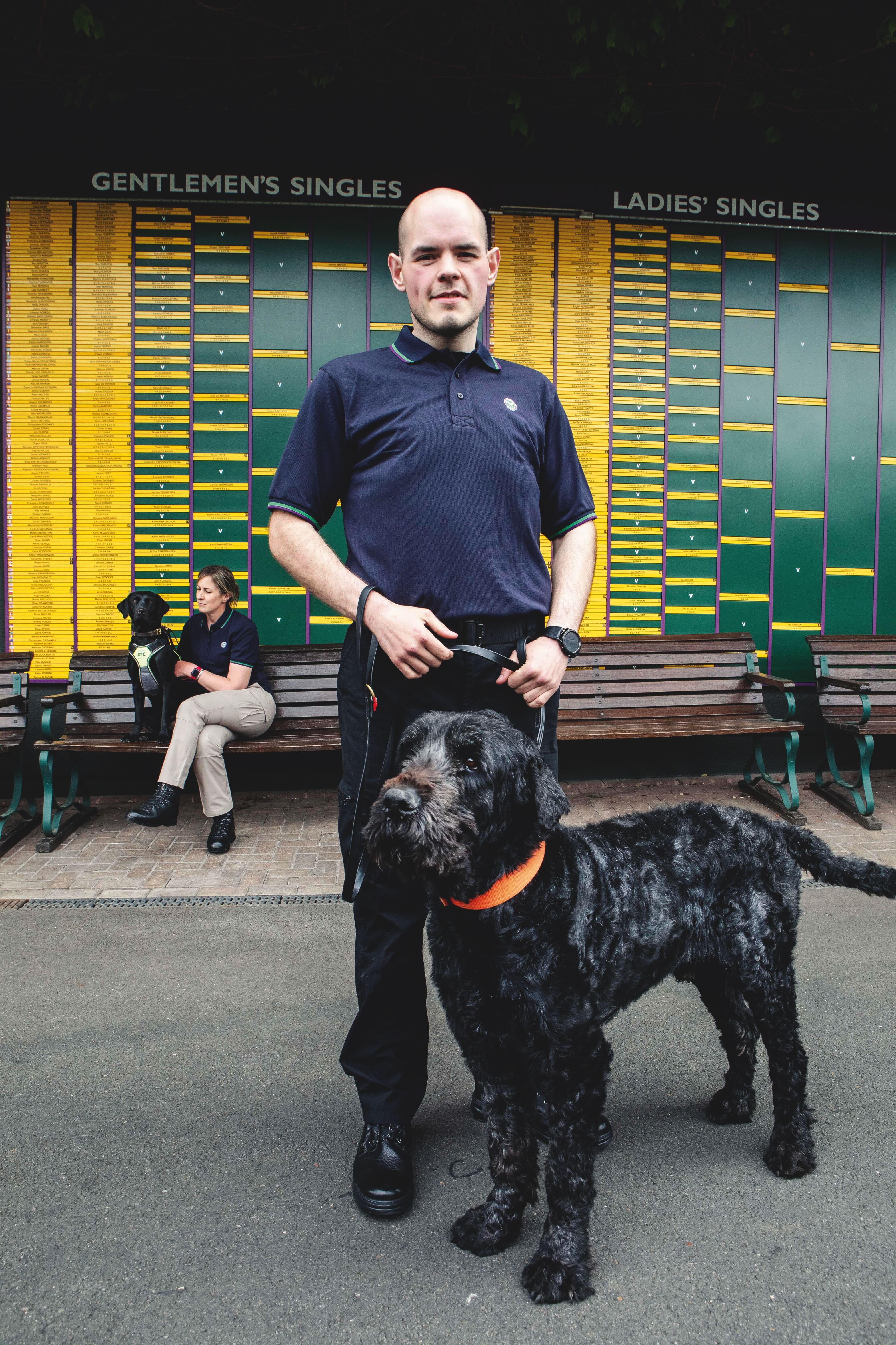 Faye Benson, Explosive dog search handler with Moo (black lab) Front - Ben Edwards, General Purpose Handler with Boris, a Russian Terrier