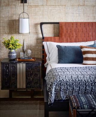 close-up of bed and side table with patterned fabrics