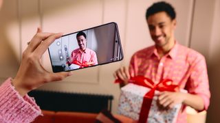 Samsung Galaxy S26 Ultra taking picture of someone with birthday present 