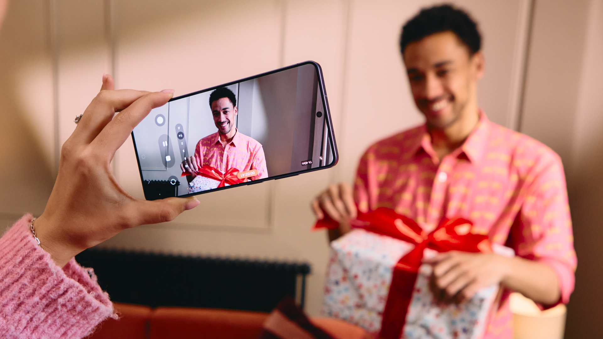 Samsung Galaxy S26 Ultra taking picture of someone with birthday present 