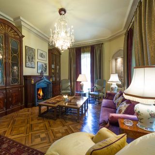 room with yellow cushions wooden table and white lamp