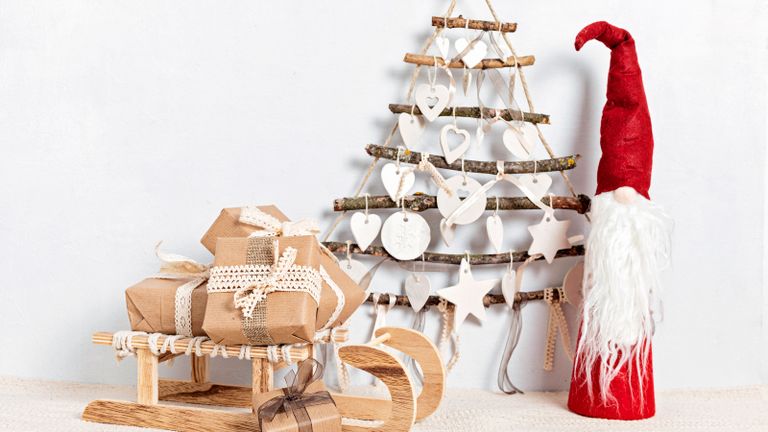 DIY Christmas tree made from twigs and natural twine and gifts wrapped in craft paper