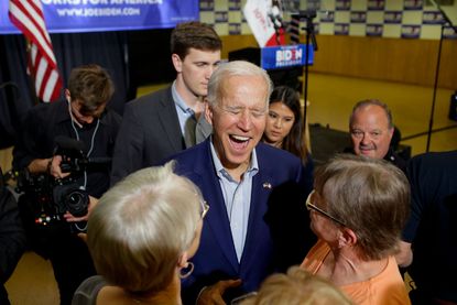 Joe Biden laughs with supporters in Iowa