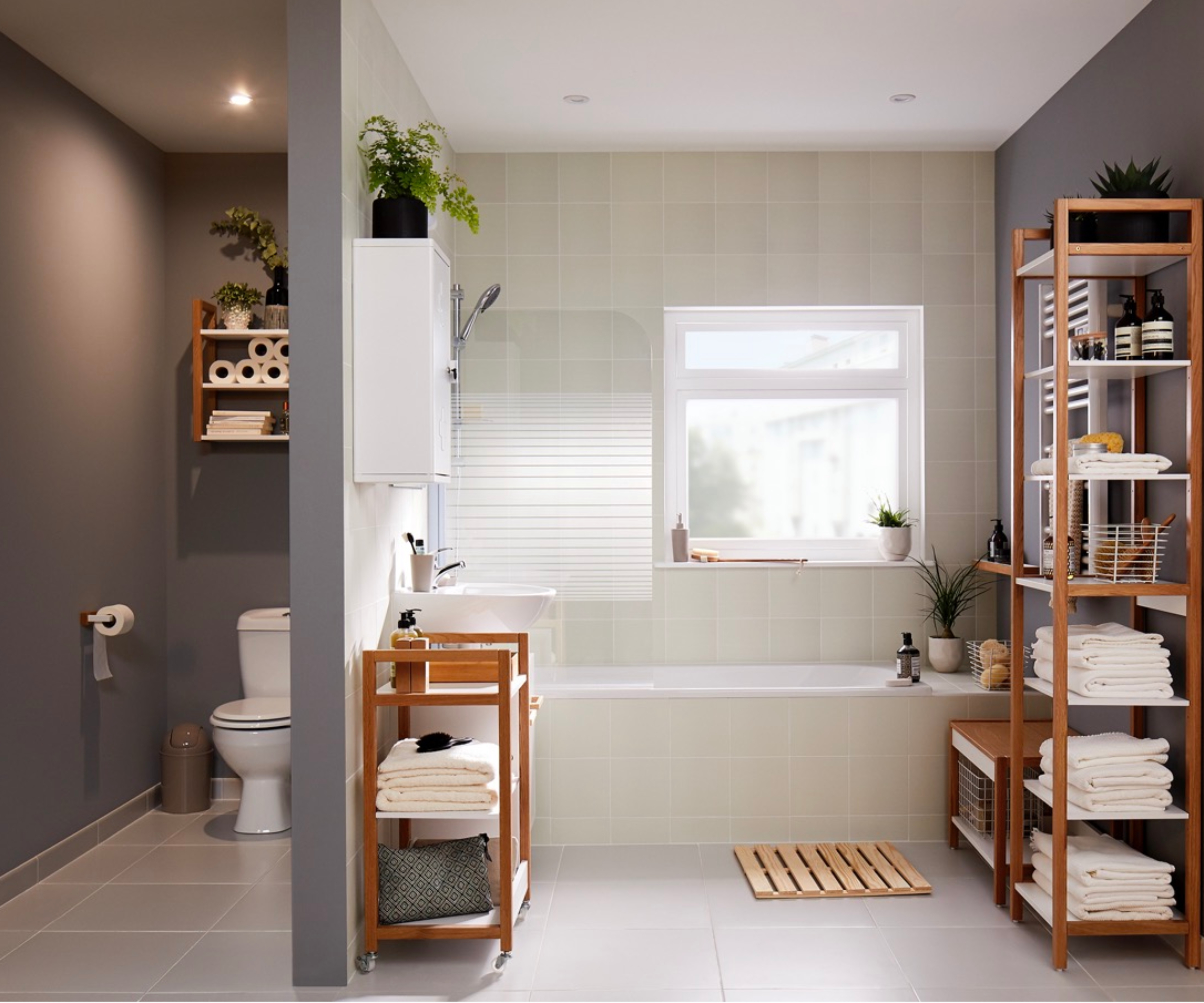 bathroom with dark grey painted walls in toilet area and to one side of bath area
