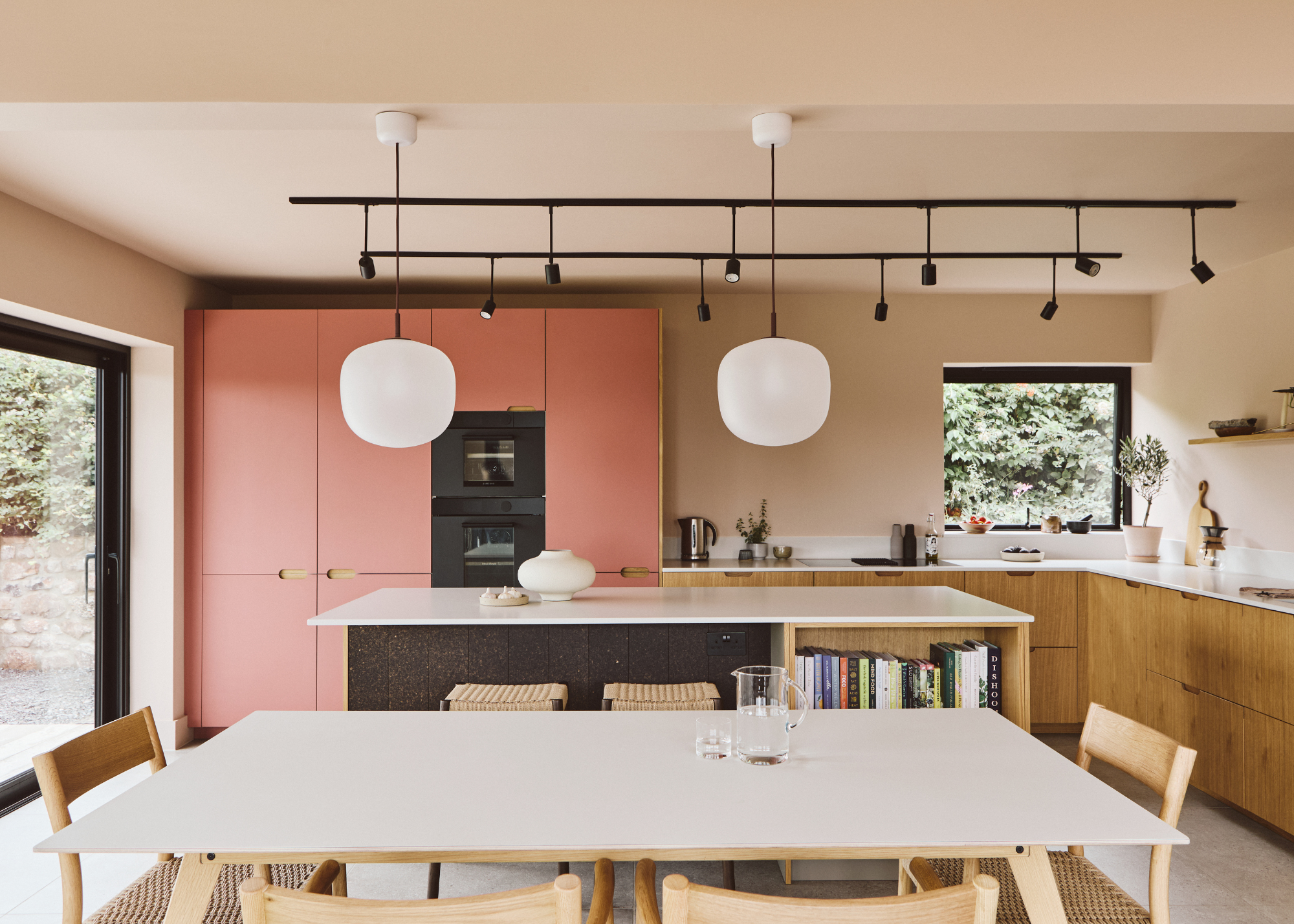 kitchen extension with pendant lights, wooden cabinetry and pink cabinets