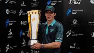 Carlos Ortiz holds up the International Series Oman trophy after winning in 2024