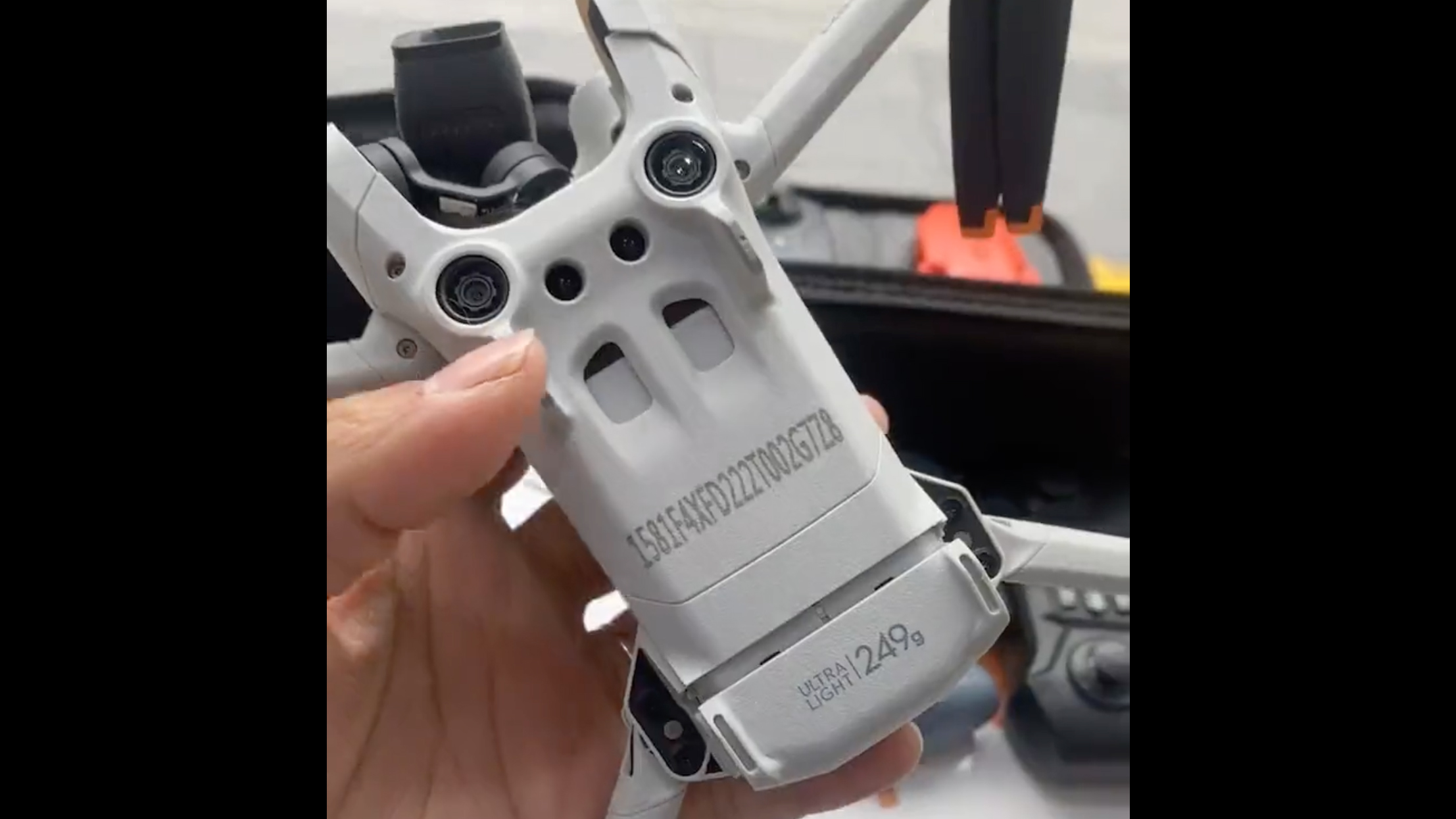 A hand holding a prototype of the DJI Mini 3 Pro