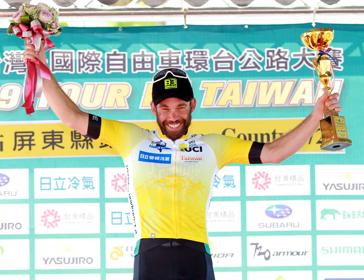 Floyd's Pro Cycling's Jonny Clarke in yellow on the Tour de Taiwan podium