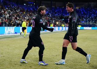 KANSAS CITY, KANSAS - FEBRUARY 19: Lionel Messi of Inter Miami celebrates with teammate Tadeo Allende after scoring the team's first goal during a 2025 Concacaf Champions Cup first leg match between Sporting Kansas City and Inter Miami at Sporting Park on February 19, 2025 in Kansas City, Kansas. (Photo by Kyle Rivas/Getty Images)