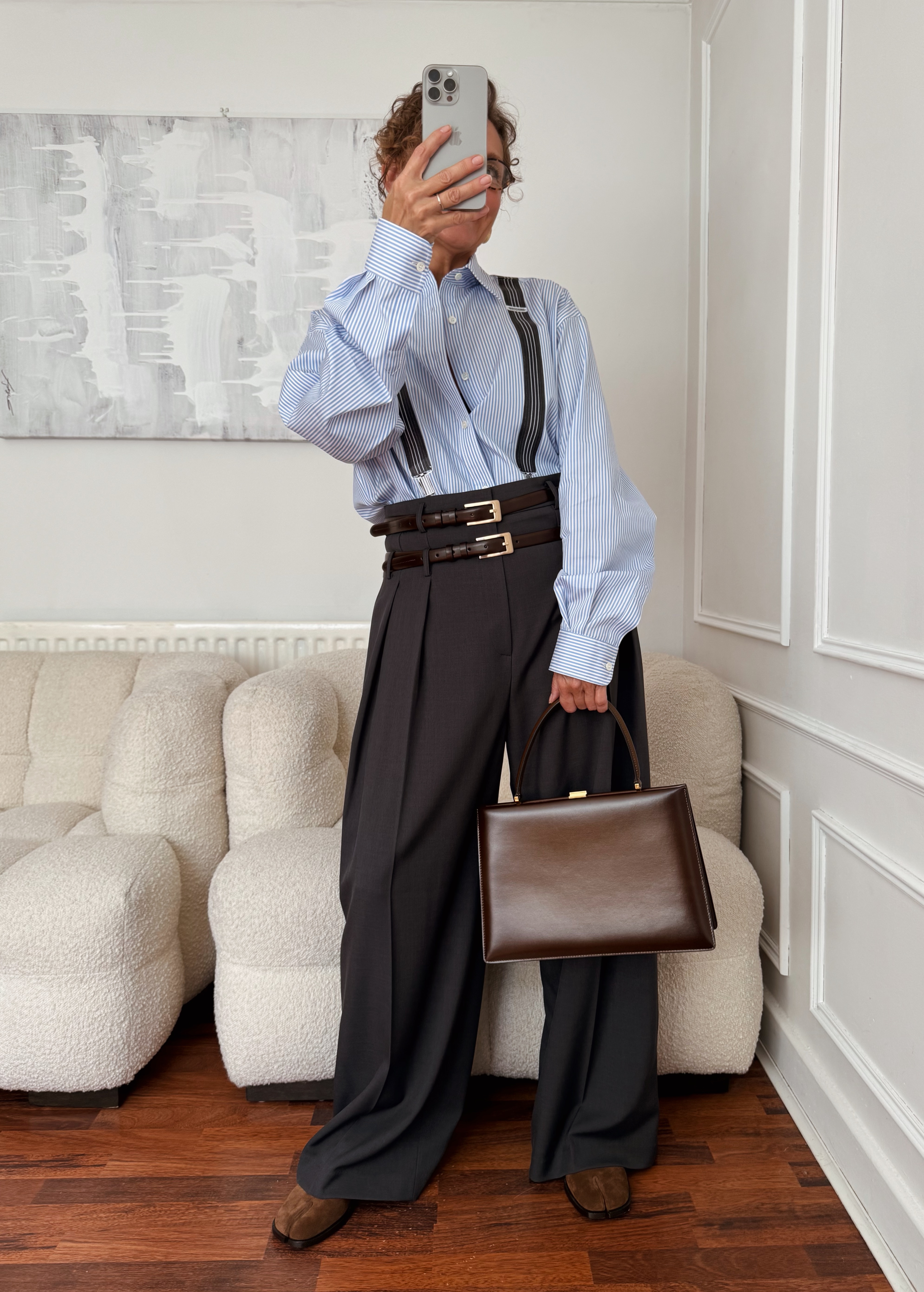 Renia Jazdzyk wearing a work outfit for mature women&amp;mdash;a button-down, high-waisted trousers, with two belts.