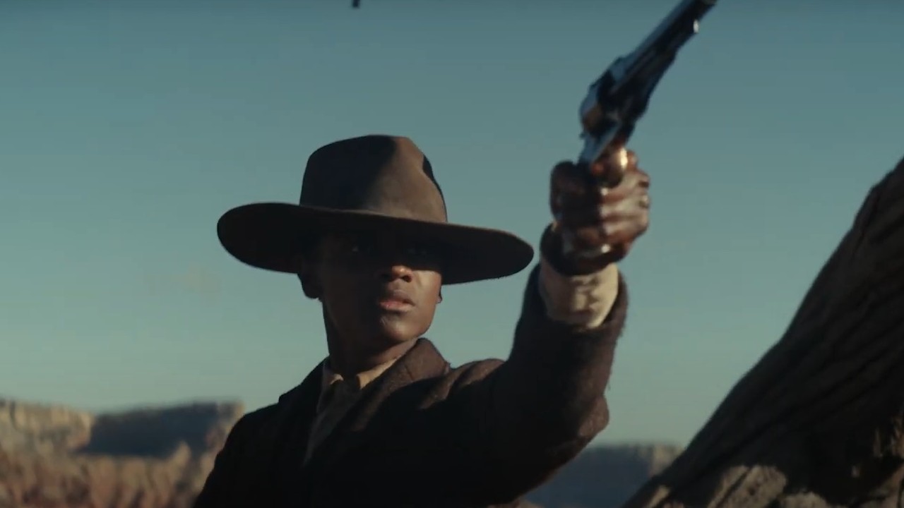 Letitia Wright with a pistol raised in Surrounded