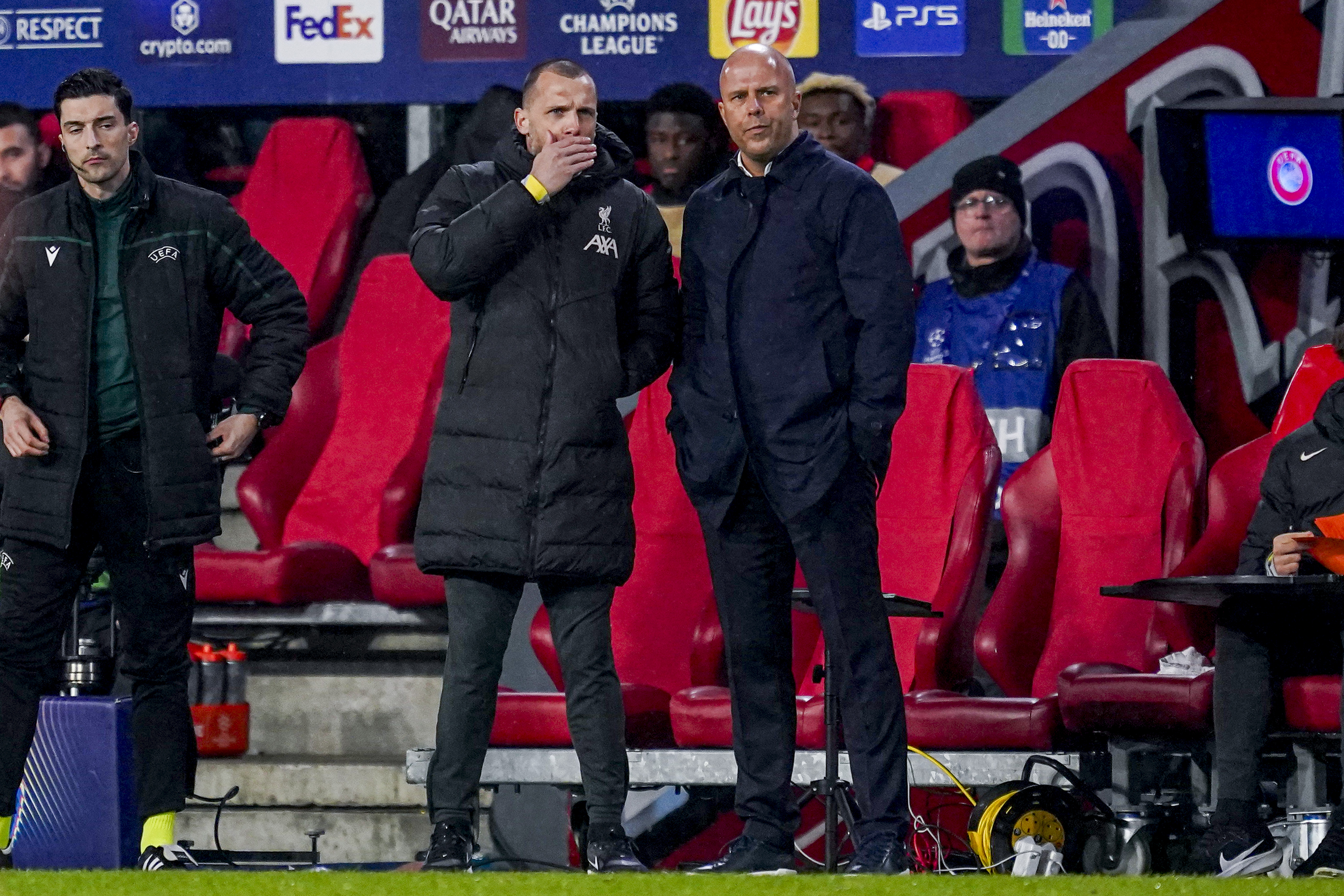 Liverpool head coach Arne Slot and Liverpool assistant coach John Heitinga looks on during the UEFA Champions League 2024/25 League Phase MD8 match between PSV Eindhoven and Liverpool FC