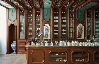 Wooden counter & wooden shelves displaying glass bottles