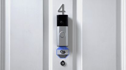 Ring Battery Video Doorbell Plus (2nd Gen) mounted above peephome on front door