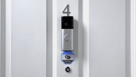 Ring Battery Video Doorbell Plus (2nd Gen) mounted above peephome on front door