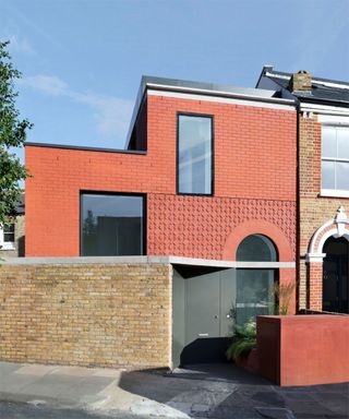 Red brick modern house extension with arch glass door arch window