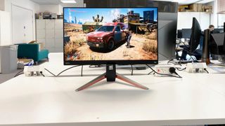 BenQ Mobiuz EX270QM looking straight on at the camera on a white desk