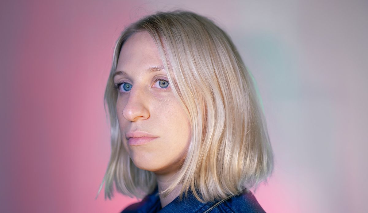 image of a blonde white woman on a pinky background