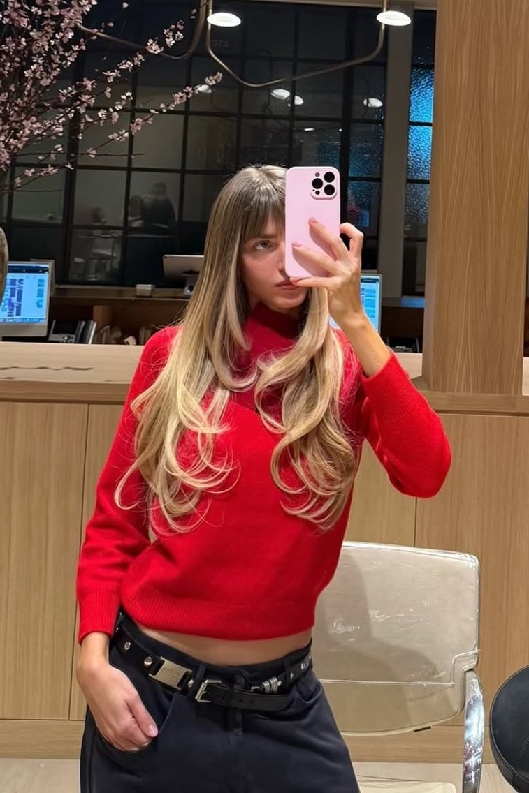 A model with their hair cut in long layers.