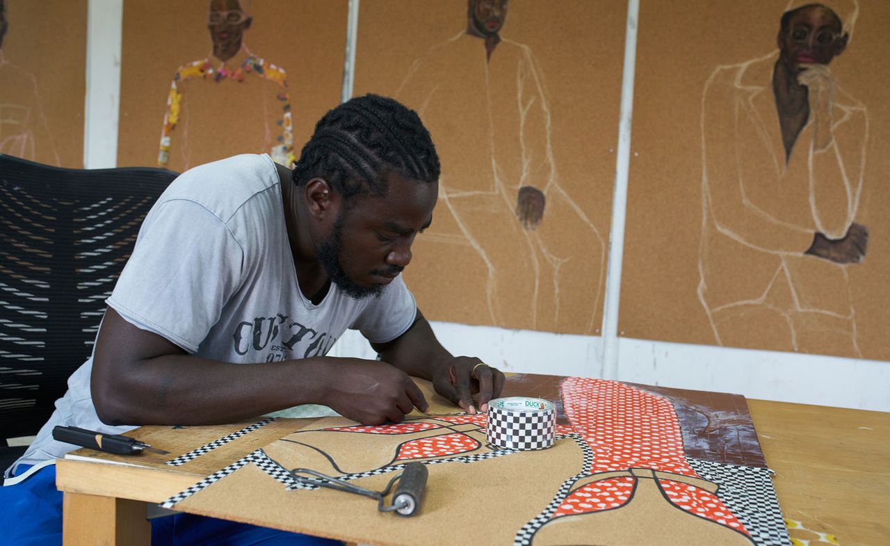 Portrait of Ghanaian artist Serge Attukwei Clottey working on a piece in his studio ahead of a show &#039;Beyond Skin&#039; at Simchowitz Gallery Los Angeles