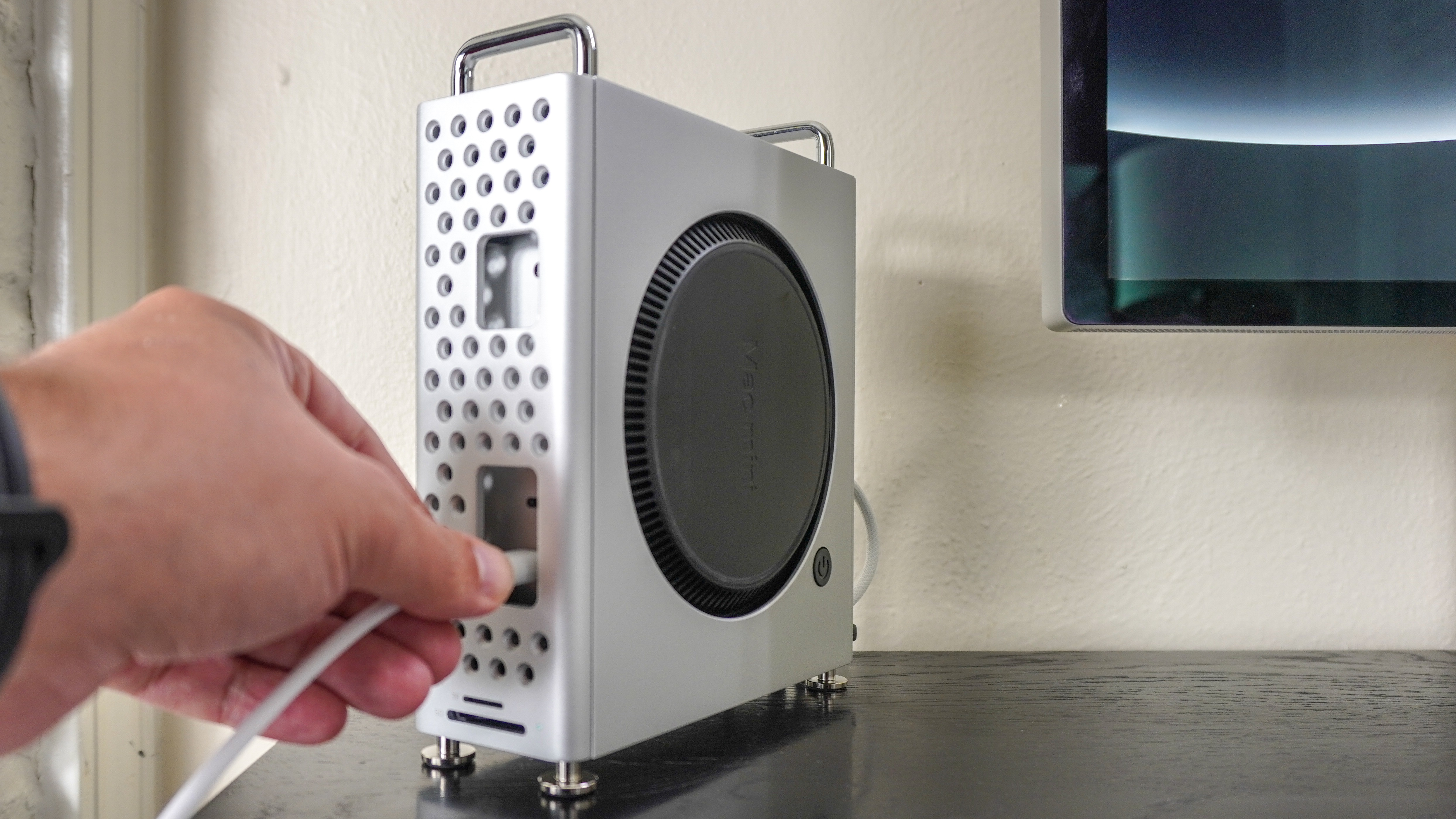 Plugging a USB-C cable into a Mac mini M4 inside the Orico MiniPro Dock Case