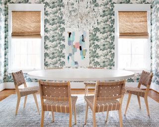 A dining room wall idea with green patterned wallpaper and modern wooden dining set