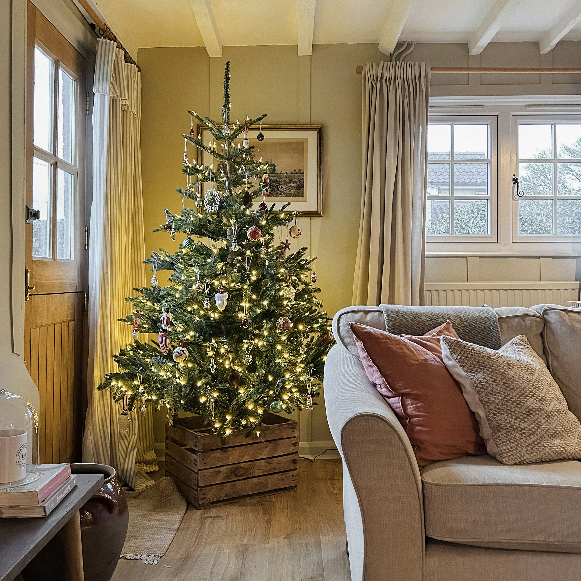 lit and decorated tree in a country living room