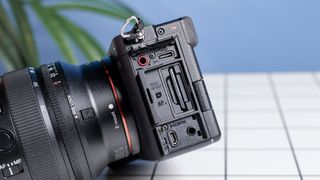 The Sony A7CR on a white table with a blue wall in the background