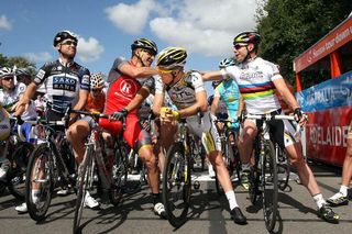 Lance Armstrong (RadioShack) shakes Cadel Evans' (BMC Racing Team) hand on the start, watched by Stuart O