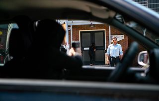 Peter Barlow and Carla fail to spot a car approaching and a gun pointing at them!