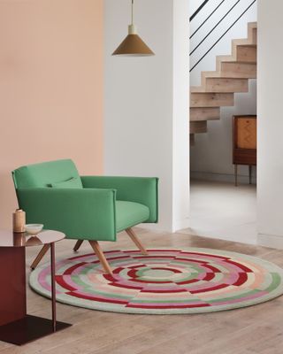 Round, patterned, multicoloured rug in contemporary home interior